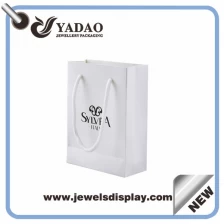 China Newest wholesale design white paper bag gift bag shopping bag with free customized logo in China manufacturer