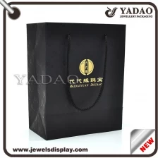 China Black good quality god logo pattern around shopping bag hard paper manufacturer