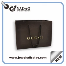 China Custom size and color line paper packaging bag with handles and logo printed manufacturer
