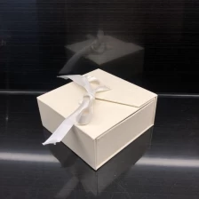 China Elegant white textured paper cardboard packaging jewelry box sponge insert ribbon tie manufacturer