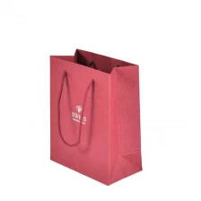 China Hot Stamping Silver Logo Customize Red Fancy Paper Bag With Cotton Rope Handles manufacturer