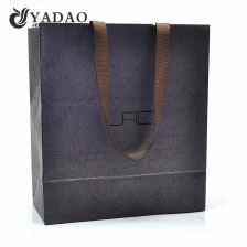 China Top quality 210g 230g 250g fancy paper material with texture ribbon handle paper shopping gift bags manufacturer