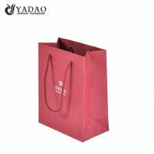 China Yadao Bolsa de papel extravagante de alta qualidade Bolsa de presente de Natal Bolsa vermelha para compras com corda torcida e estampagem quente fabricante