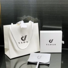 China Customized shopping paper bag with cotton rope and ribbon closure white color gift packaging bag manufacturer