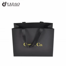 China fancy paper bag ribbon handle shopping paper bag texture finish paper packaging bag manufacturer