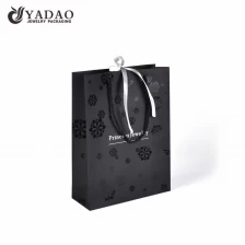 China fancy paper shopping paper bag jewelry packaging paper bag twisted rope gift bag with UV coating pattern manufacturer