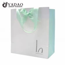 China Yadao printing paper bag jewelry packaging bag shopping bag gift bag in three colors printing with ribbon handle and closure manufacturer