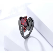 China Custom unique wave design black gold ruby gemstone finger ring for women manufacturer
