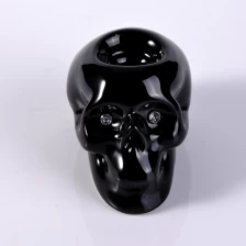 China Suporte de vela de luz do chá em cerâmica preta crânio para decoração de casa fabricante