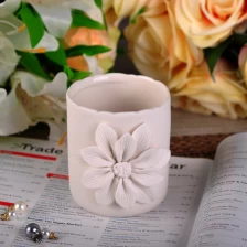 China Hot Sale Round Cylinder Embossed White Flower Ceramic Candle Holder manufacturer