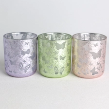 China electroplated spray color opaque laser hollow butterflies pattern glass candle jar with lid manufacturer