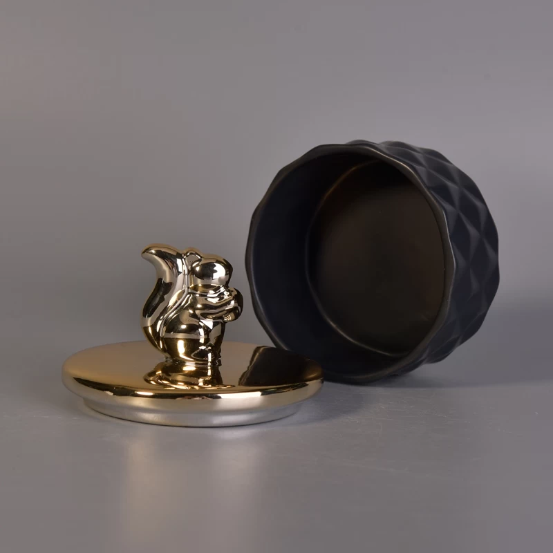 Matte black ceramic containers with gold animal lids
