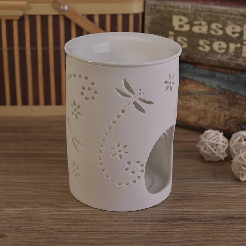 White ceramic candle burner with hellow out dragonfly pattern