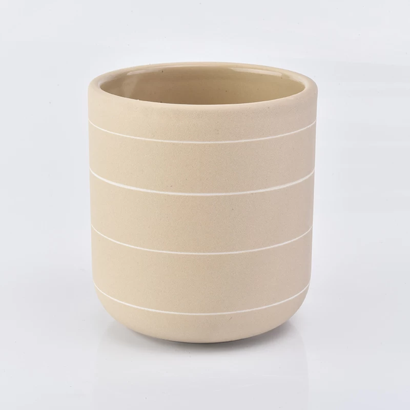 curved bottom matte yellow ceramic candle jar with white lines