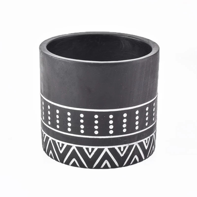 black candle jar with white decorative lines