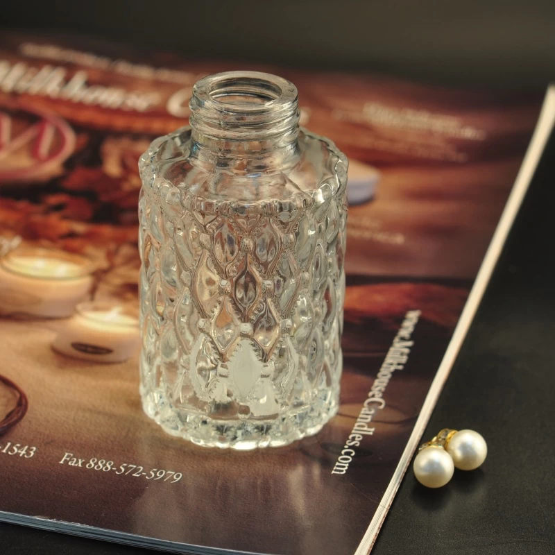 ODM Transparent embossed glass container oil essential perfume spray bottles factory