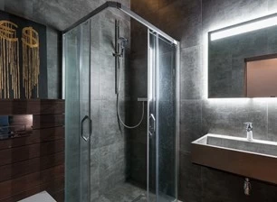 Why are there many transparent glass designs in hotel bathrooms?