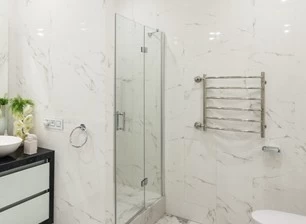 Why do many people install glass partitions in their own bathrooms?