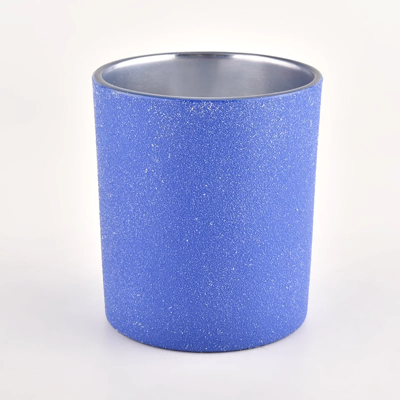 blue glass candle jar with metallic silver inside
