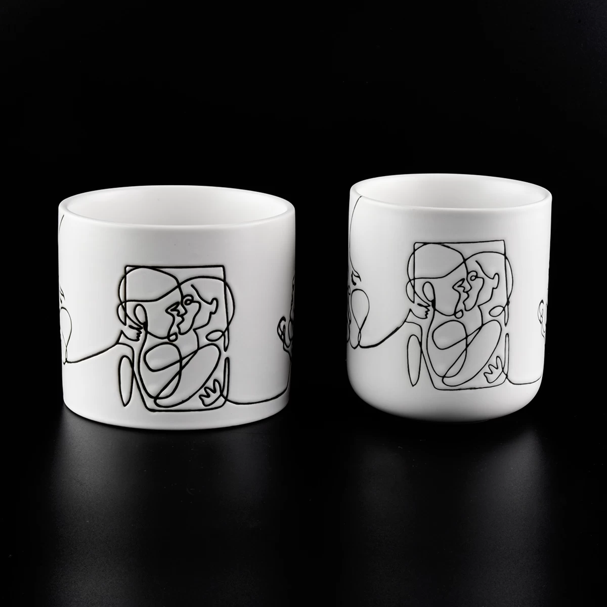 white ceramic candle jars with black printing