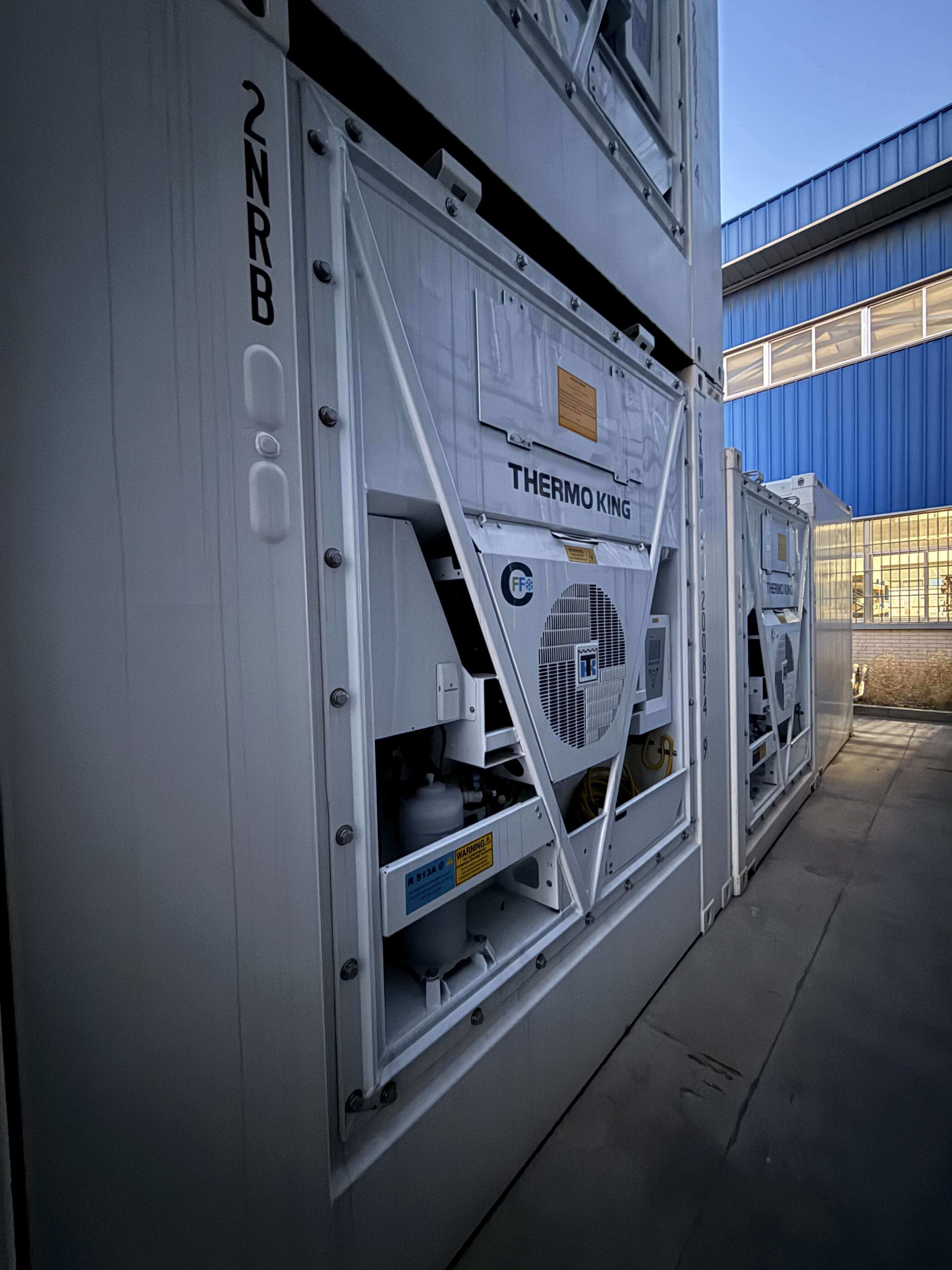 Stacked ultra-wide reefer containers at port showing proper positioning and spacing