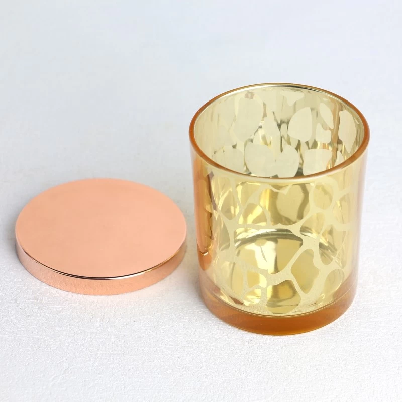 China electroplated laser hollow pattern yellow glass candle jar scented candles with golden lid manufacturer