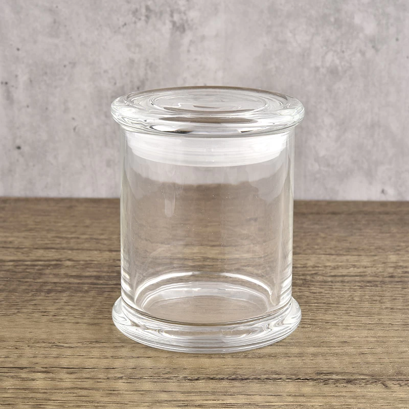 Tall column style clear glass candle jars paired with glass lids