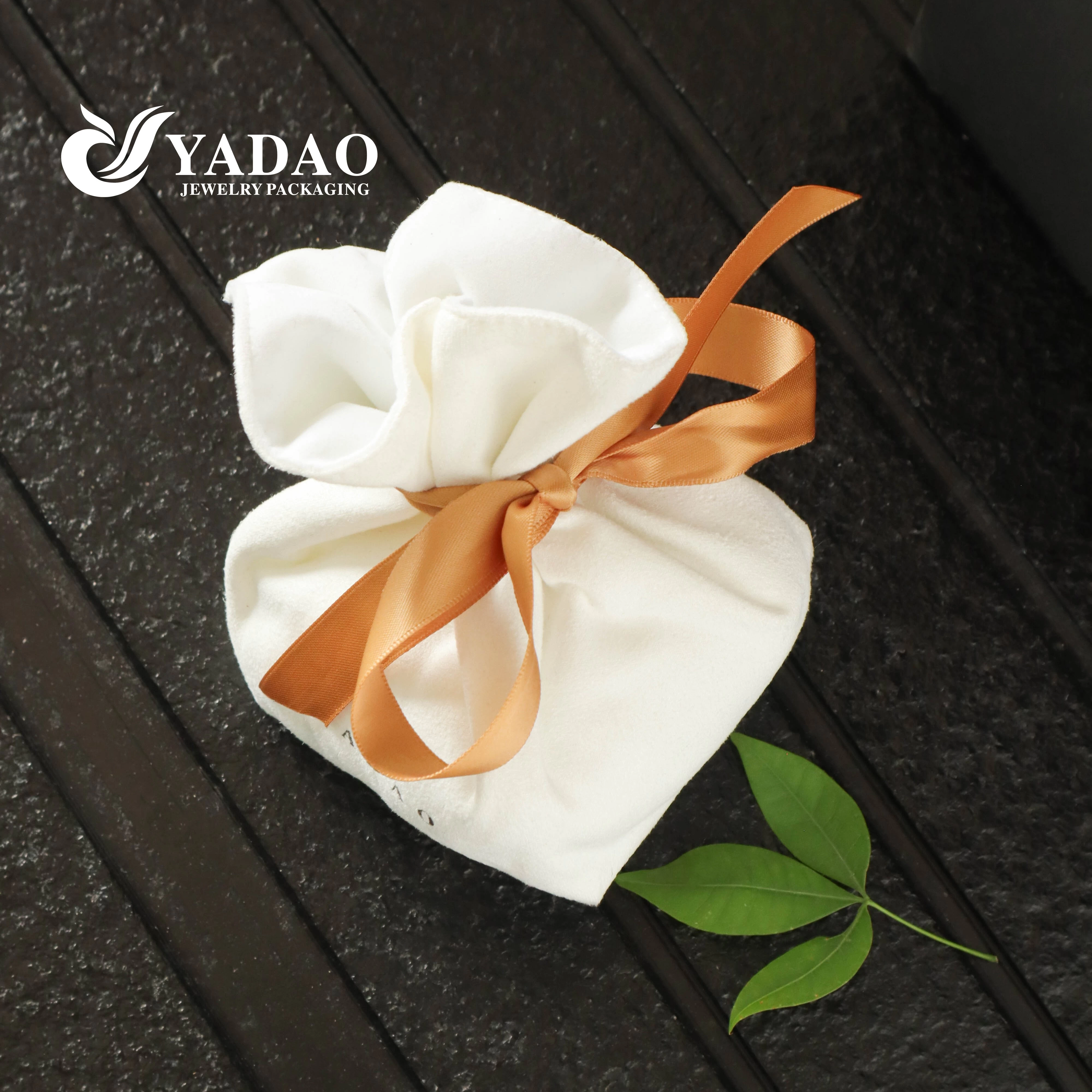 white suede gift packaging with silk ribbon bow knot