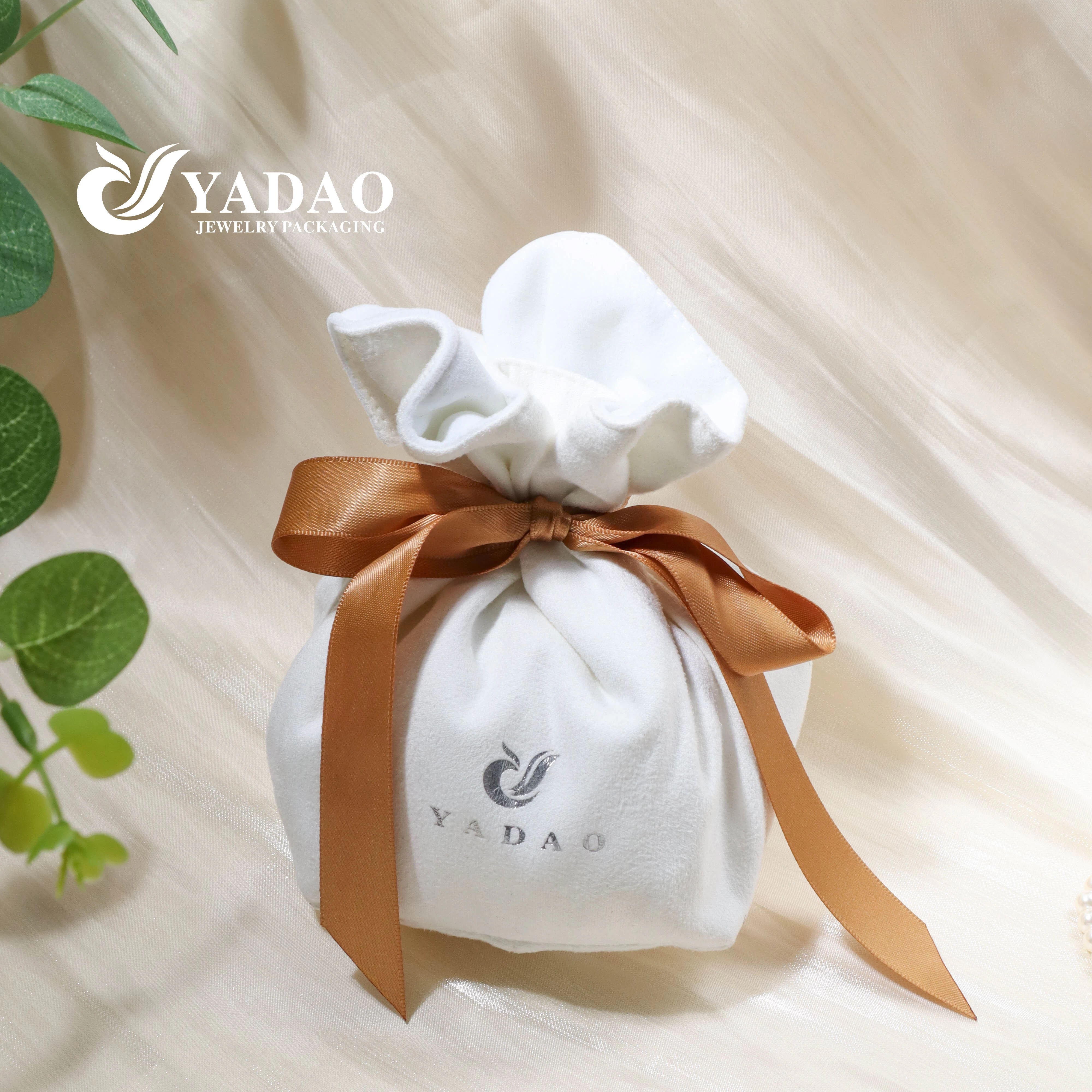 white suede gift packaging with silk ribbon bow knot