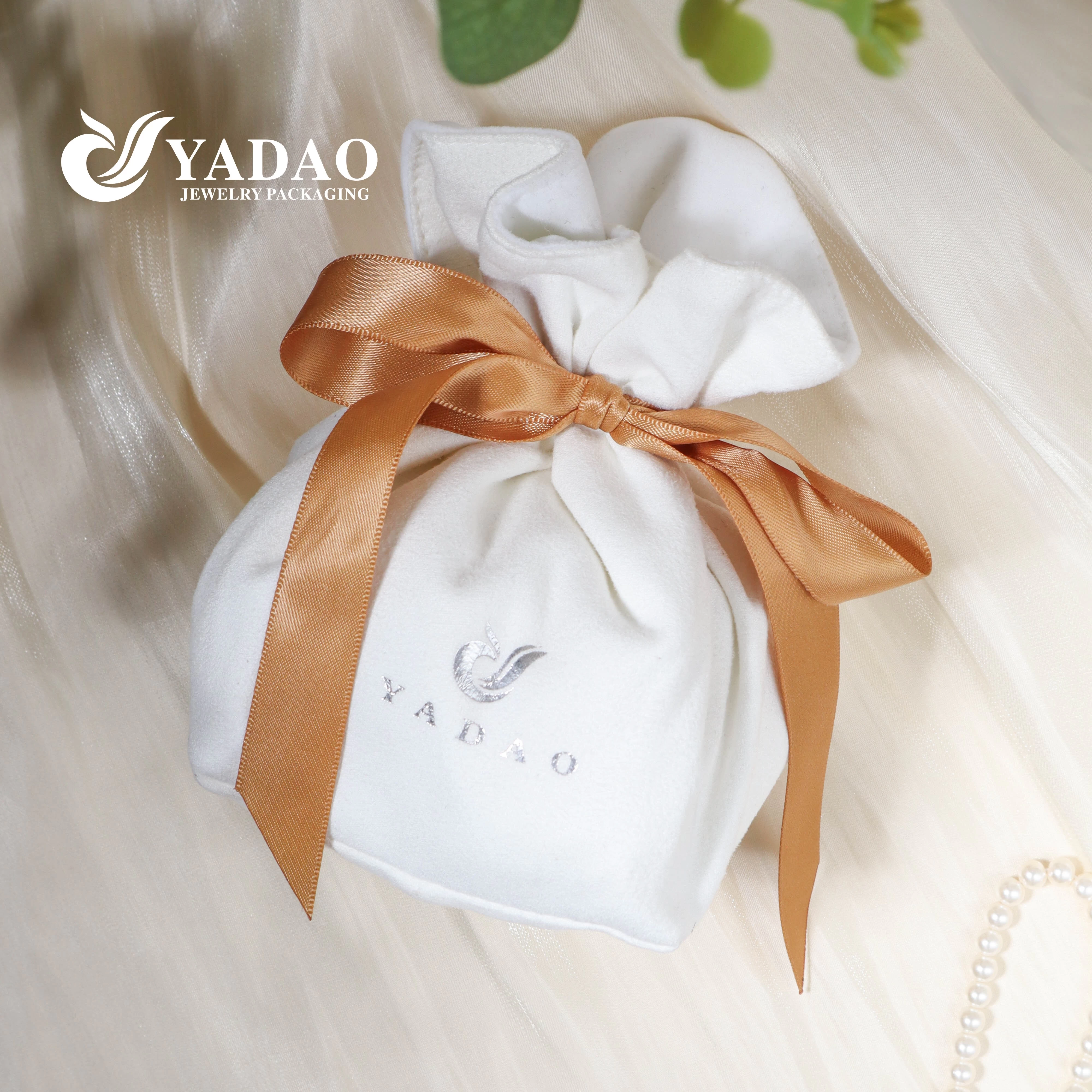 white suede gift packaging with silk ribbon bow knot