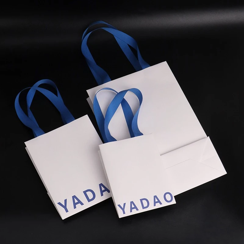 Ανυψώστε την επωνυμία σας με προσαρμοσμένες τσάντες λευκού χαρτιού και μπλε βαμβακερές λαβές