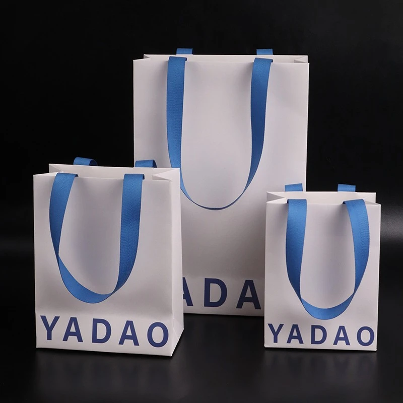 Ανυψώστε την επωνυμία σας με προσαρμοσμένες τσάντες λευκού χαρτιού και μπλε βαμβακερές λαβές