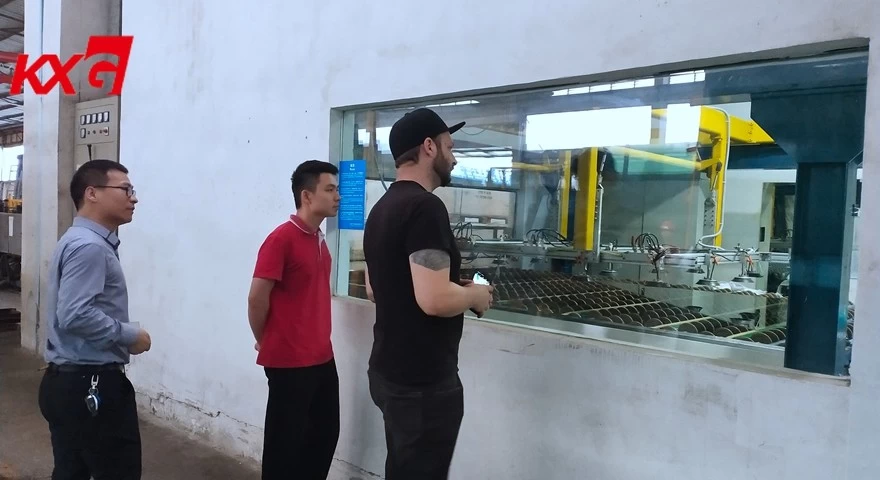 American customer watching PVB laminating glass processing outside of clear room KXG