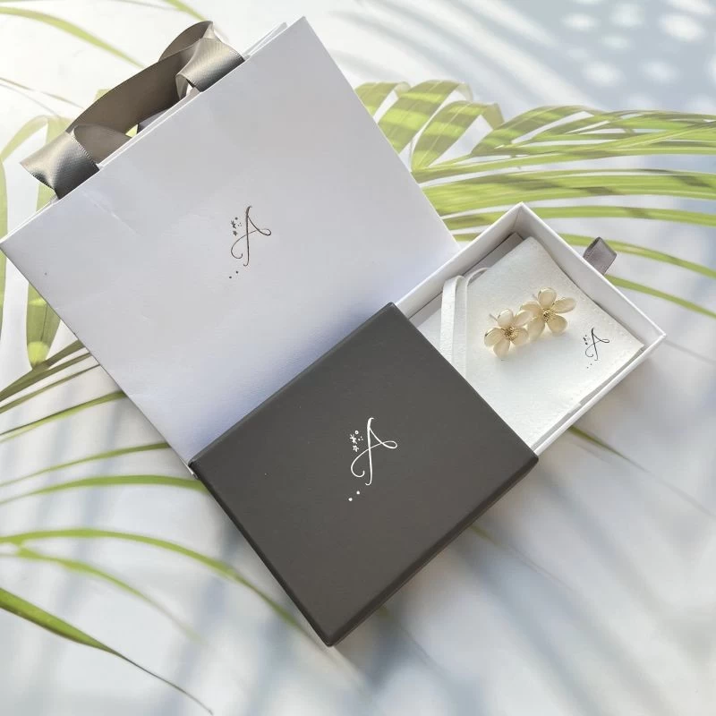 Customized jewelry packaging set with a gray drawer box white microfiber pouch and a white paper bag
