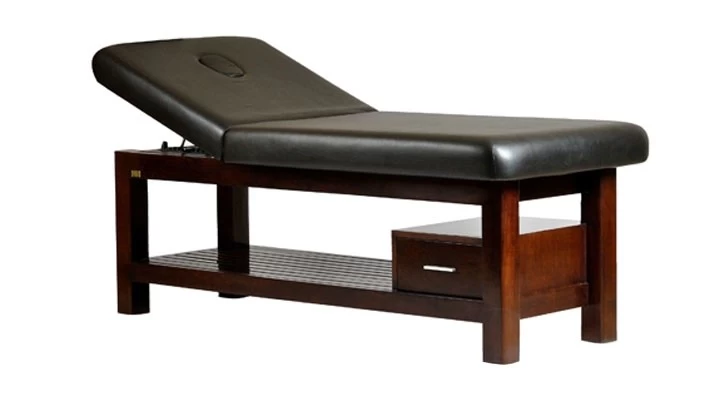 Angad is professional hardwood massage bed for western massages. Simple in design but strongly built with rounded corner top cushion design. The backrest can be inclined manually and there is ample size drawer for storing spa essentials. Wooden struts at the bottom add to aesthetics of this professional massage. There is a face hole cutting and available in lot of leatherette options.