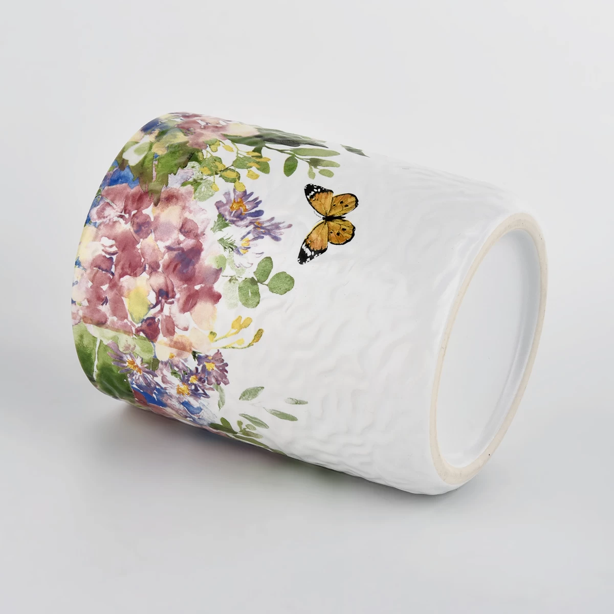 white ceramic vessel with colorful print