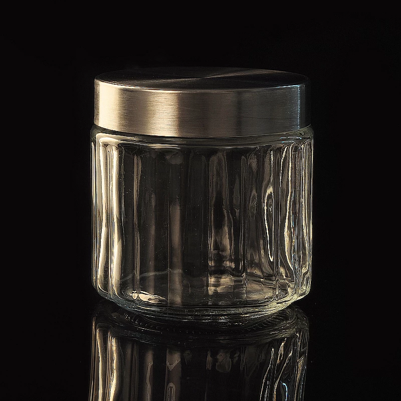 Vertical patterned glass candle jar with metal lid