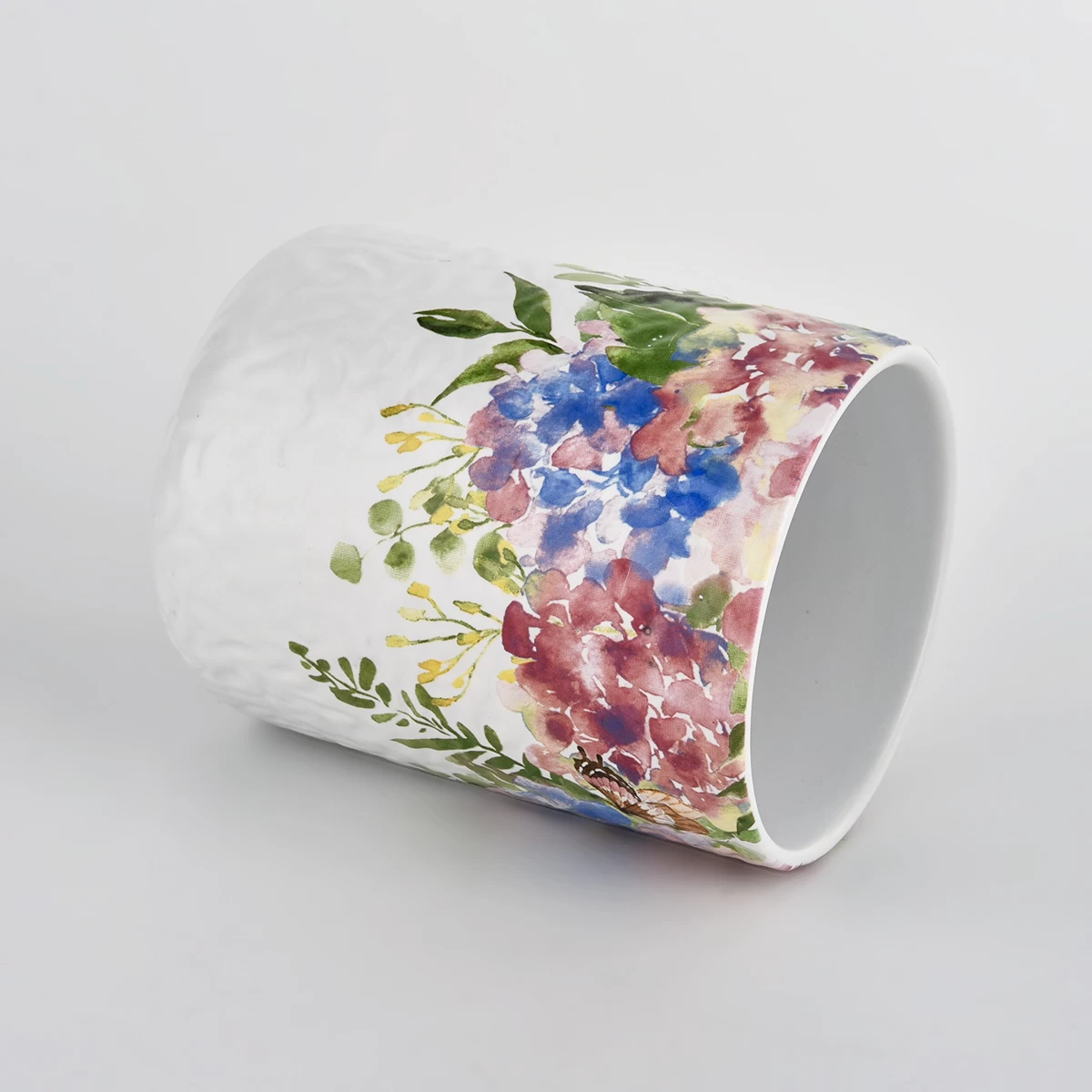 white ceramic vessel with colorful print