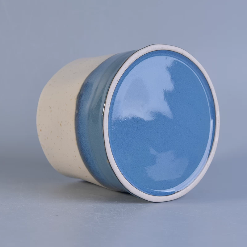 white and blue ceramic candle container