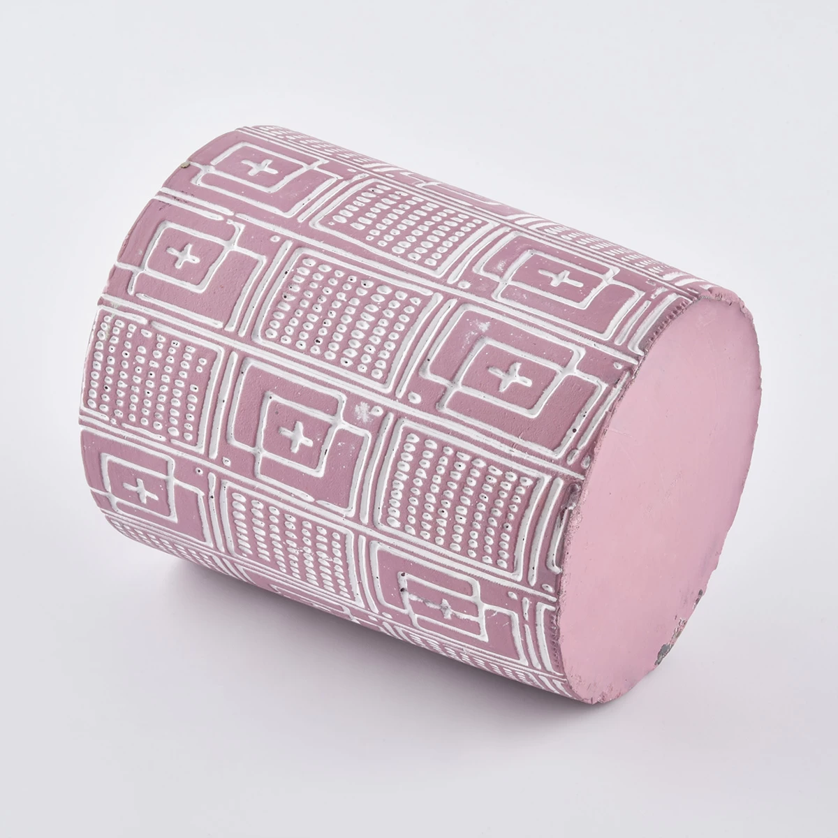 pink candle jar with white dcement ebossed pattern  