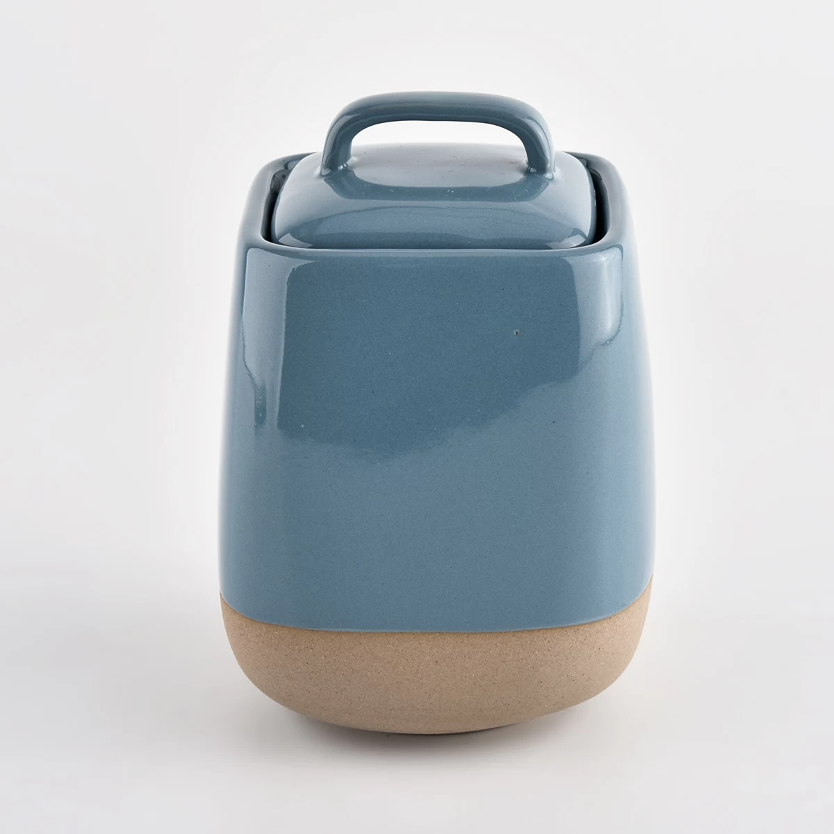 glossy blue ceramic vessel with sandy soil bottom 