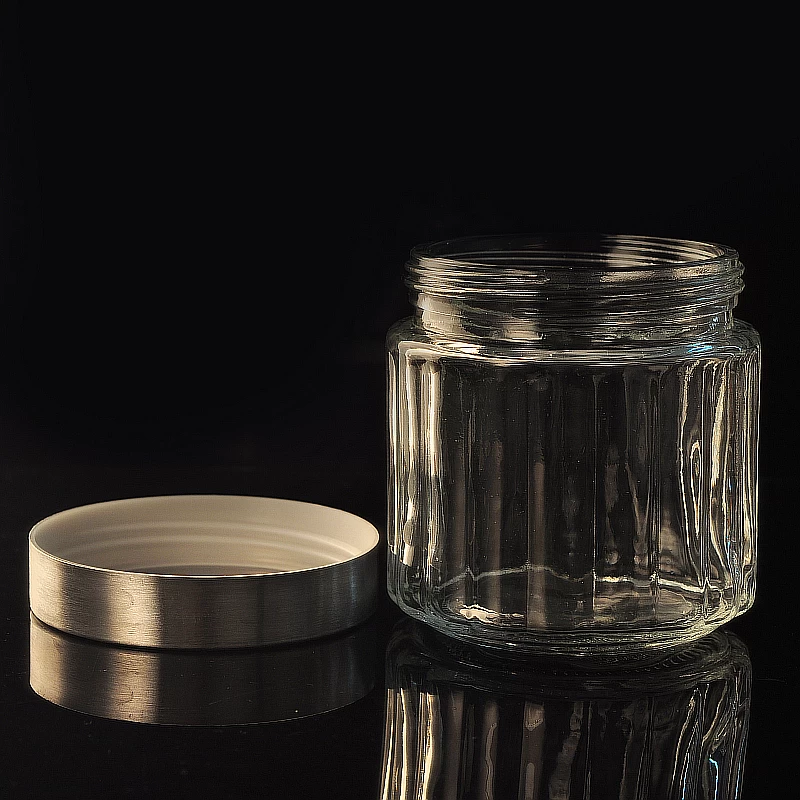 Vertical patterned glass candle jar with metal lid