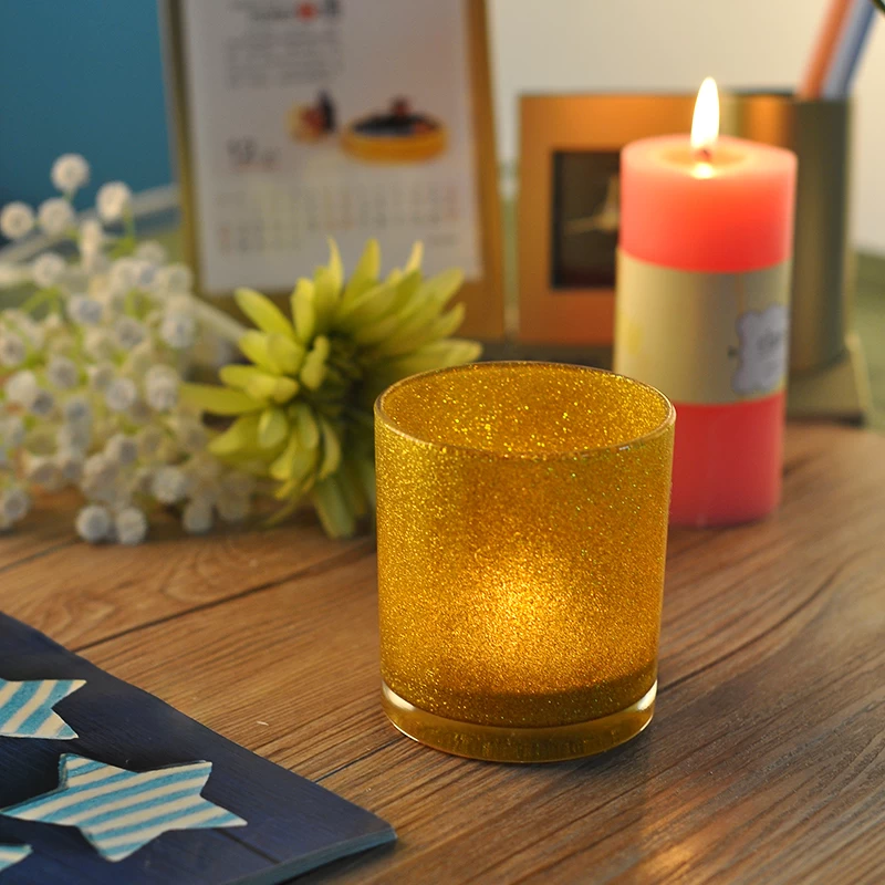Glass candle holder with golden glitter