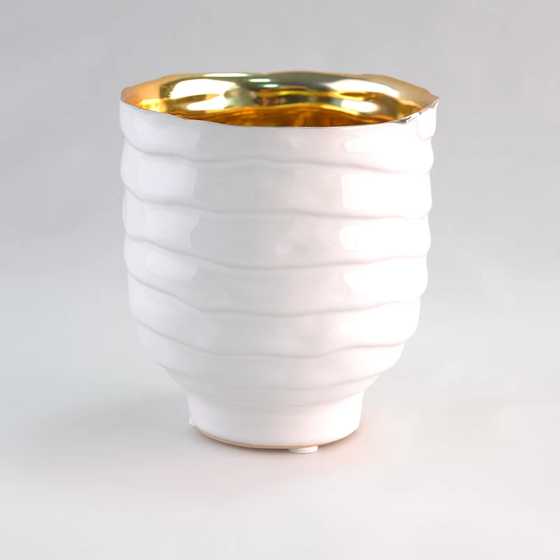 White ceramic candle holders with gold inside
