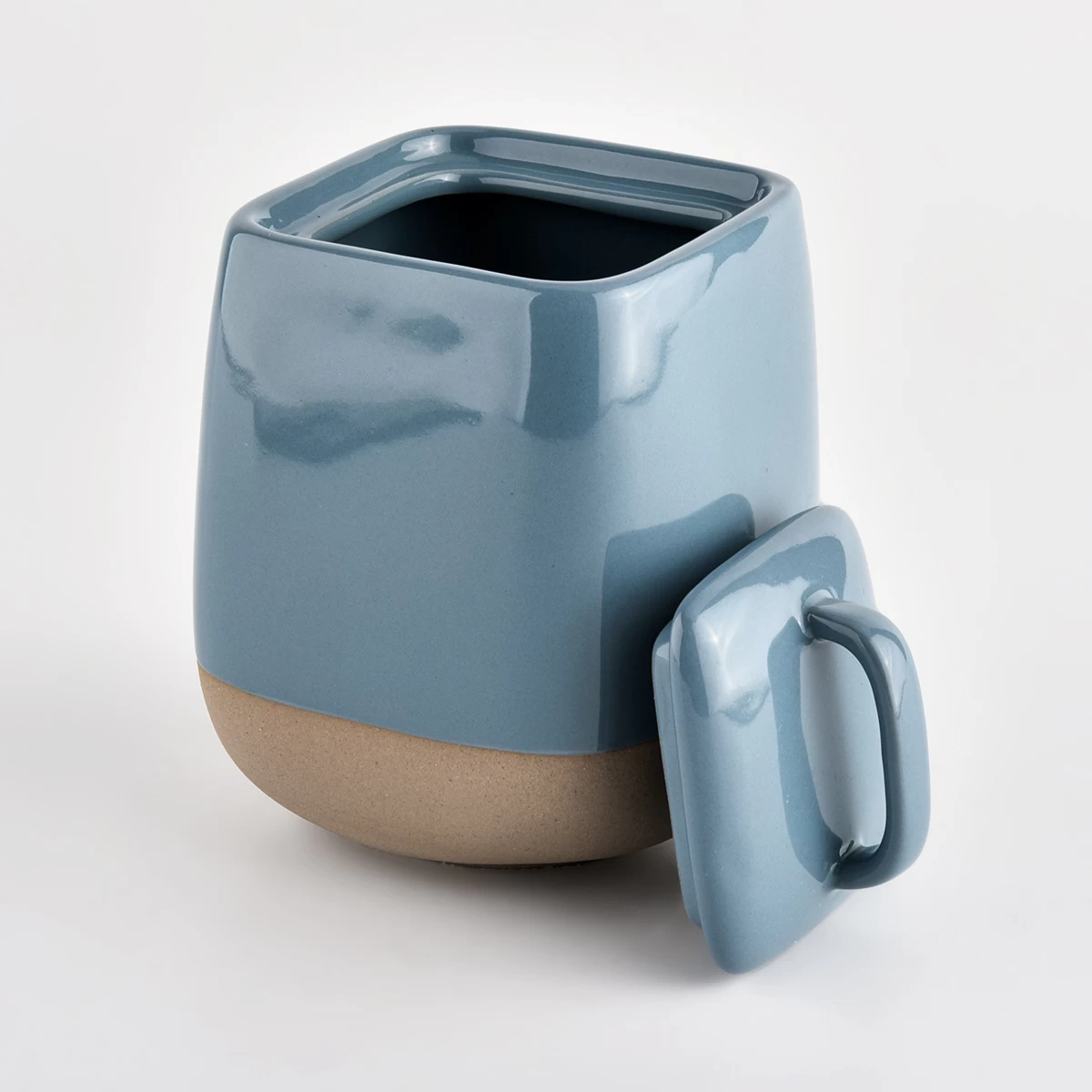 glossy blue ceramic vessel with sandy soil bottom 