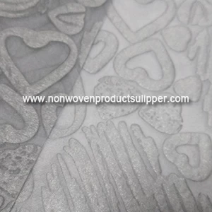 China Wholesale Light Grey Heart-shaped Embossing GT-HSLIGR01 PP Spunbond Non Woven Wrapping Paper For Presents manufacturer