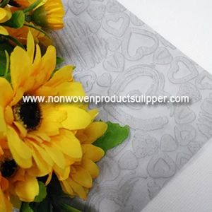 China Wholesale Light Grey Heart-shaped Embossing GT-HSLIGR01 PP Spunbond Non Woven Wrapping Paper For Presents manufacturer