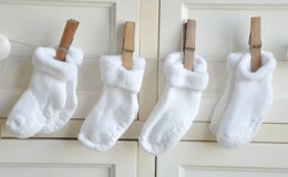 The socks that baby wears are more important than the shoes