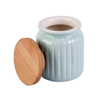 China Light blue round ceramic candle jar with wood lid for home decoration manufacturer