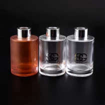 China Customized orange clear glass oil diffuser bottle fragrance with metal lid car decoration wholesale manufacturer
